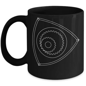Könnte beinhalten: Schwarze Keramik-Kaffeetasse mit einer weißen Umrandung eines Rotationsmotors.