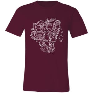 Pode incluir: Camiseta bordô com um desenho de linha branca de um motor. A ilustração do motor está centrada na frente da camiseta. A camiseta tem mangas curtas e gola redonda.