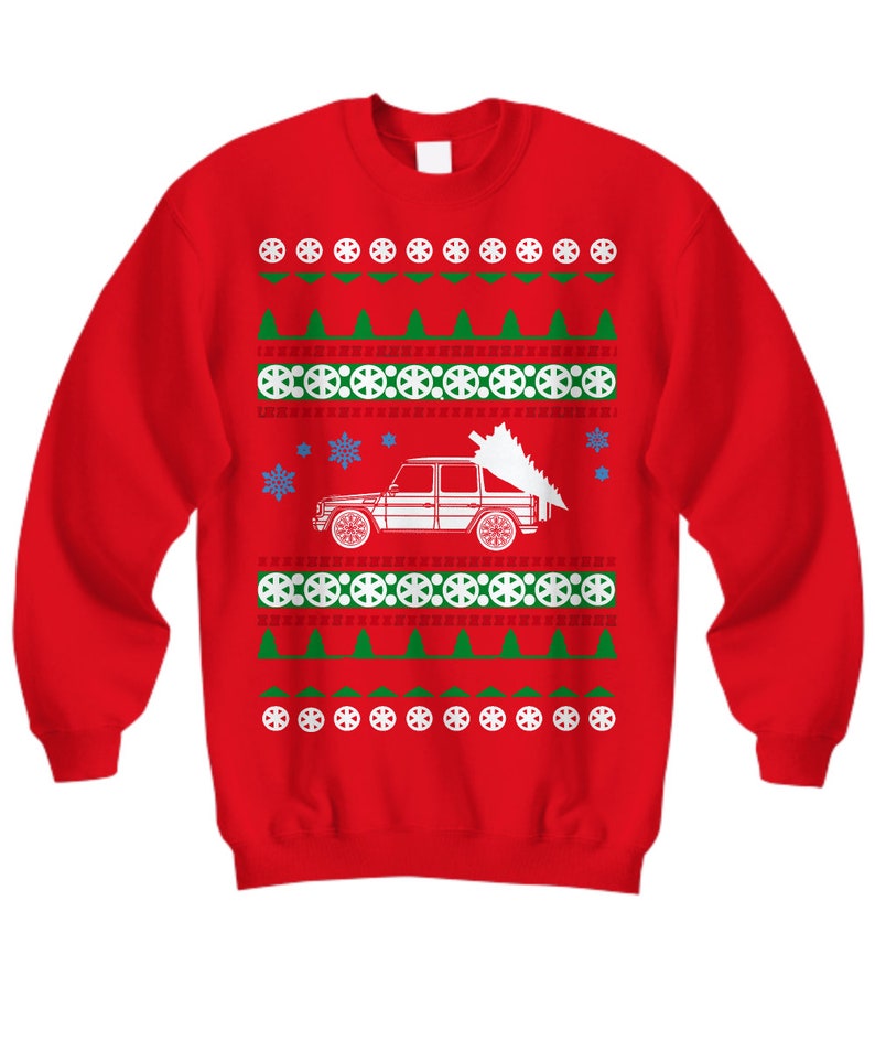 May include: Red Christmas sweater with a white car carrying a Christmas tree. The sweater has a green and white snowflake pattern.