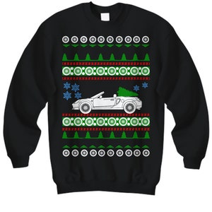 May include: Black Christmas sweater with a white outline of a car with a Christmas tree on top. The sweater has a green, red, and white snowflake pattern.
