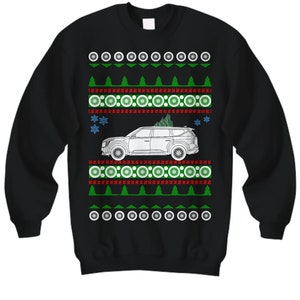 May include: Black sweatshirt with a festive design. The design includes a white car with a Christmas tree on top, green trees, red and green geometric patterns, white snowflakes, and white circles. A holiday-themed apparel item.