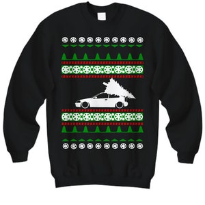 May include: Black Christmas jumper featuring a white car silhouette carrying a Christmas tree. The jumper has a repeating pattern of green trees, red and white snowflakes, and white tyre rims.