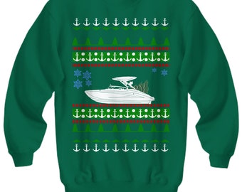 May include: Green Christmas sweater with a white boat and anchor pattern. The boat is decorated with a Christmas tree.