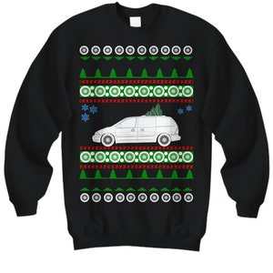 May include: Black sweatshirt featuring a Christmas-themed design. The design includes a white minivan with a Christmas tree, green trees, snowflakes, and circular patterns in white, red, and green.