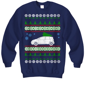 May include: A navy blue Christmas sweater with a white car carrying a Christmas tree. The sweater has a red and green snowflake pattern.