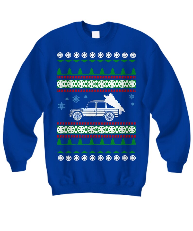 May include: A blue Christmas sweater with a white car carrying a Christmas tree. The sweater has a repeating pattern of snowflakes, Christmas trees, and tire tracks.