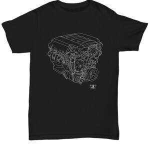 May include: A black t-shirt with a white outline of a car engine. The engine is detailed with all of its parts, including the pistons, crankshaft, and camshaft. The text "TOOL AND DIE" is printed below the engine.
