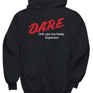 May include: Black hooded sweatshirt with a front pocket and drawstring. The red text on the front reads "D.A.R.E. Drift cars Are Really Expensive."