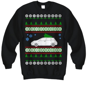 May include: Black Christmas sweater with a white outline of a car with a Christmas tree on top. The sweater has a red and green snowflake pattern.