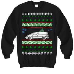 May include: Black Christmas sweater with a white van carrying a Christmas tree. The sweater has a red and green pattern with snowflakes.