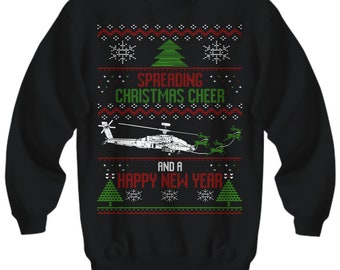 May include: Black Christmas sweater with a green Christmas tree, snowflakes, and a helicopter flying over the text "Spreading Christmas Cheer and a Happy New Year".