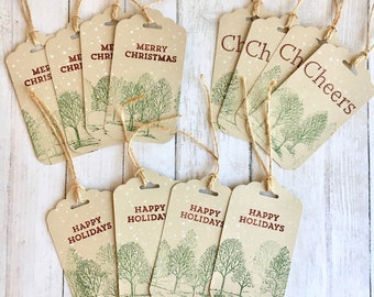 May include: A set of ten brown paper gift tags with a snowy forest scene and various holiday greetings. The tags are tied with twine and feature the text "Merry Christmas", "Happy Holidays", and "ChCh ChCheers".