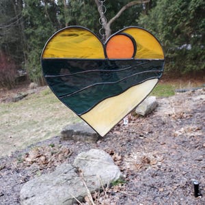 stained glass heart with sunset over ocean