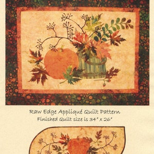 May include: A fall-themed quilt pattern with the text "Fall Memories." The design features a pumpkin and autumn leaves. The finished quilt size is 34" x 26". A table runner design is also shown, measuring 36" x 14".