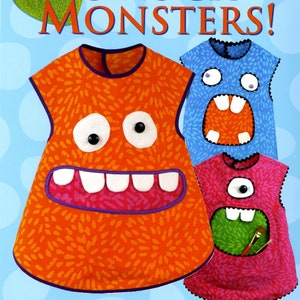 May include: A book cover featuring three colorful smock monsters with different facial expressions. The book title is "Smock Monsters!" and includes the text "Includes sizes 18 mo.-2T, 3T, 4T, 5, 6, 7. Get creative! Lots of mouth, eye, teeth options! Pattern RRD 314 by Rebecca Anderson, with monster faces by Adam Toht and Ben Toht."