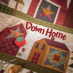 May include: A quilt pattern book titled "Down Home" by One Sister featuring a patchwork quilt with a red barn, a house, and a star design. The quilt is made with various fabrics in shades of red, green, brown, and yellow.