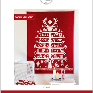 May include: A red wool applique quilt featuring a white tree design with various ornaments. The quilt measures 32 x 40 inches and is titled "Jul i Scandinavia" by Sherri Noel. The design includes a reindeer head at the top.
