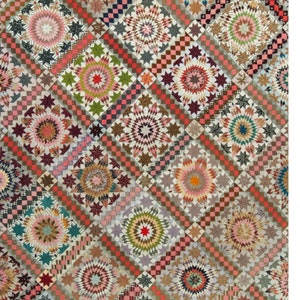 May include: A quilt pattern called "Star Upon Stars" with a patchwork design featuring a variety of colors and patterns. The quilt is 64 inches by 74 1/2 inches and is described as a "Laundry Basket Quilt".