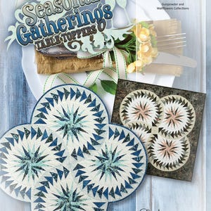 May include: A quilt pattern book titled "Seasonal Gatherings Table Toppers" featuring a quilt design with three circular patterns in shades of blue, green, and white. The book is from Quiltworx.com and features foundation paper piecing.