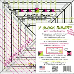 May include: A clear, square Y Block Ruler with black, pink, and green markings. The ruler features measurements in inches and text that reads "Y BLOCK RULER" and "Designed by Cathey Laird". It is designed for quilting and block creation.