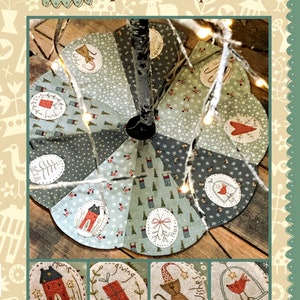 May include: A handmade Christmas tree skirt with a patchwork design featuring various holiday motifs, including houses, birds, gifts, and a cat. The skirt is made of different fabrics in shades of green, gray, and red. The text "The Giving Tree Skirt" is printed at the bottom of the image.
