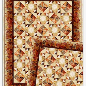 May include: A quilt with a geometric pattern in shades of beige, brown, and orange, with a border of autumn leaves. The quilt is rectangular and features the text "Reflections of Autumn II".