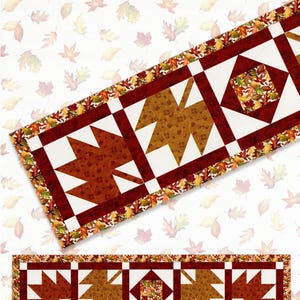 May include: A fall-themed table runner with a leaf pattern. The runner is 20 inches by 76 inches and features a design of brown and white geometric shapes with leaf accents. The text "Fall Hues Table Runner" is visible.