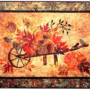 May include: A wheelbarrow filled with autumn leaves, sunflowers, and a pumpkin. Two blue birds are perched on a branch above the wheelbarrow.