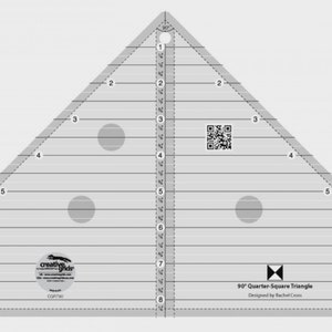 May include: A clear plastic 90° Quarter Square Triangle ruler with markings in inches. The ruler has three circles for marking fabric and a QR code. The text on the ruler reads "90° Quarter Square Triangle Designed by Rachel Cross".