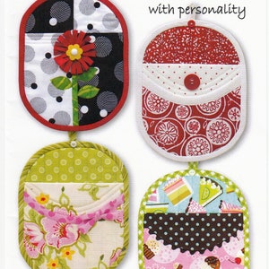 May include: Four colorful quilted pot holders with different designs. The pot holders are oval shaped with a loop at the top for hanging. The designs include a flower, a pocket, a floral pattern, and a cupcake pattern.