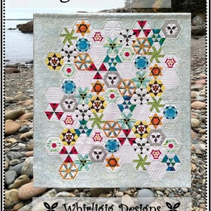 May include: A colorful quilt with a geometric design featuring hexagons and star-like shapes. The quilt has a light blue background and is adorned with various colors including red, yellow, green, and blue. The text "A Cog in the Wheel" and "Whirligig Designs" are displayed.
