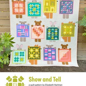 May include: A cream-colored quilt featuring whimsical forest animal figures holding colorful patchwork designs. The quilt showcases a variety of geometric patterns in shades of orange, green, blue, and pink. The text "Show and Tell" is visible at the bottom.