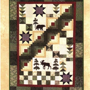 May include: Quilt pattern titled "Under The Stars" with a design featuring a bear, moose, and trees. The pattern is from Cotton Tales, original designs by Pamela J. Curo.