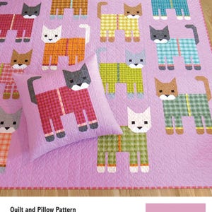 May include: A quilt and pillow pattern titled CATS IN PAJAMAS by Elizabeth Hartman. The design features a light purple quilt top decorated with multiple cat figures wearing plaid pajamas in various colors, including red, green, yellow, and teal.