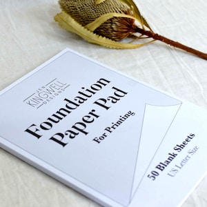 May include: A white paper pad with the text "Foundation Paper Pad" and "Jen Kingwell Designs" printed on the front. The pad is for printing and contains 50 blank sheets in US Letter size.