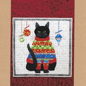 May include: A black cat wearing a colorful Christmas sweater with a red, green, blue, and white pattern. The cat is sitting on a white background with red ornaments hanging from the top. The text "Bah Humbug" is written above the cat. The text "Kristadyelle@gmail.com" and "All Rights Reserved" is written below the cat.