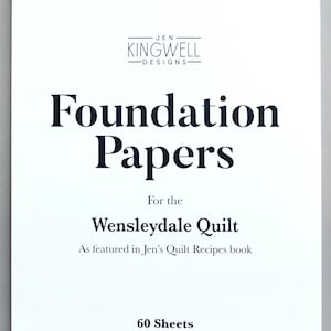 May include: A white rectangular package of Jen Kingwell Designs Foundation Papers for the Wensleydale Quilt. The cover features black text, a 60 Sheets label, and a decorative border of blue and white geometric quilt block patterns.