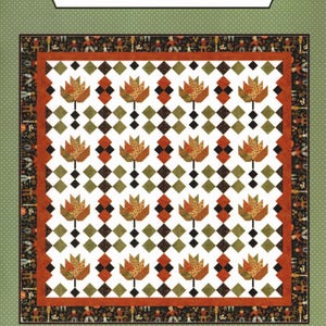 May include: A quilt pattern titled "Raking Leaves" by La Vonne Jackson. The design features repeating leaf motifs in shades of orange and brown, set against a white background with a diamond pattern. The quilt is framed with a decorative border.