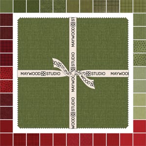 May include: A collection of fabric squares in shades of green and red, arranged around a central square. The central square is a textured green fabric, tied with a ribbon that reads "MAYWOOD STUDIO". The surrounding squares showcase various patterns and textures.