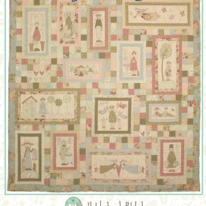 May include: A patchwork quilt titled An Angels Story featuring various rectangular panels with illustrations of angels in muted pink, green, and beige tones. The quilt is bordered by a floral print and includes the text Hatched and Patched.