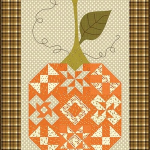 May include: A quilted pumpkin design with an orange body, green stem and leaf, and a cream-colored background. The pumpkin is made of various geometric shapes in orange and cream fabrics. The border is a brown plaid pattern.