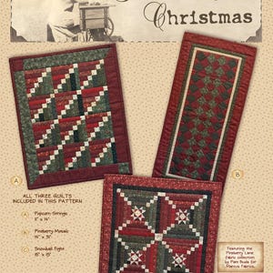 May include: A sewing pattern titled Pineberry Christmas featuring three quilt designs: Popcorn Strings 11 inches by 14 inches, Pineberry Mosaic 14 inches by 31 inches, and Snowball Fight 15 inches by 15 inches, all using the Pineberry Lane fabric collection.