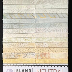 May include: A fabric bundle featuring 40 strips, each 2 1/2 inches wide, in various neutral patterns. The fabric designs include dots, swirls, and floral motifs in shades of cream, beige, and pale green. The package is labeled "Island Batik Neutral Foundations."