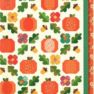 May include: A quilt pattern called "Under the Oaks" by Heather Peterson for Anka's Treasures. The pattern features a white background with orange pumpkins, green leaves, yellow and pink flowers, and brown acorns.