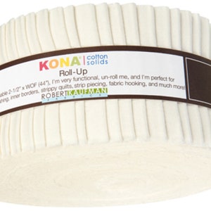 May include: A roll of Kona Cotton Solids fabric in a cream color. The fabric is rolled up and has a brown label that says "Kona Cotton Solids Roll-Up". The label also says "A usable 2-1/2" x WOF (44"), I'm very functional, un-roll me, and I'm perfect for binding sashing, inner borders, strippy quilts, strip piecing, fabric hooking, and much more." The label also has the Robert Kaufman Fabrics logo.