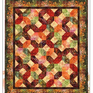 May include: A rectangular quilt titled Evanescence Gemstones Quilt by Jason Yenter, featuring a geometric pattern of interlocking squares in shades of red, orange, green, and cream, surrounded by a dark border and a floral-patterned outer edge.