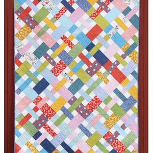 May include: A colorful quilt pattern called "Picnic" by Cluck Cluck Sew. The quilt is made with fat quarters and is available in six sizes.