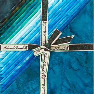 May include: A pack of 10 fat quarters of blue and green batik fabric, tied with a brown ribbon and labeled "Island Batik".