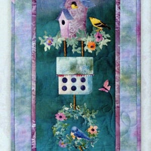 May include: A vertical fabric wall hanging titled Just Kitten Around measuring 15 1/2 inches by 46 inches. The design features stacked birdhouses, colorful flowers, butterflies, birds, and an orange cat reaching toward a hanging birdhouse.