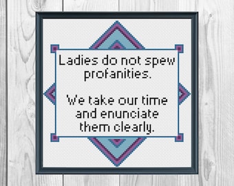 May include: A white cross-stitch embroidery with a blue and purple diamond border. The text reads "Ladies do not spew profanities. We take our time and enunciate them clearly."